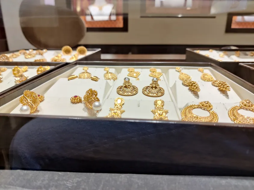 Close up gold ear rings on the display.
Image used for illustrative purpose.
Image courtesy: Getty Images/ Jimmy Gupta